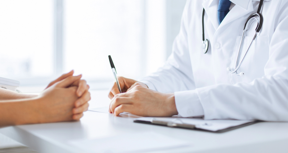 Patient and doctor taking notes