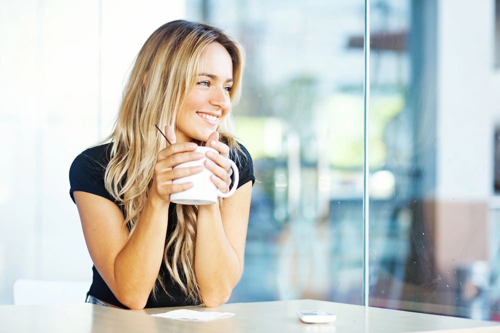 Woman drinking coffee in the morning at restaurant